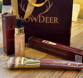 GlowDeer illuminator, brush and gift bag on a table